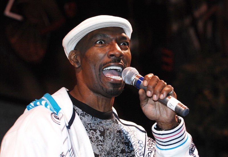 Charlie Murphy holds a microphone