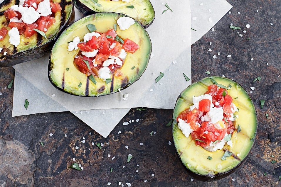 Grilled avocados filled with diced tomatoes