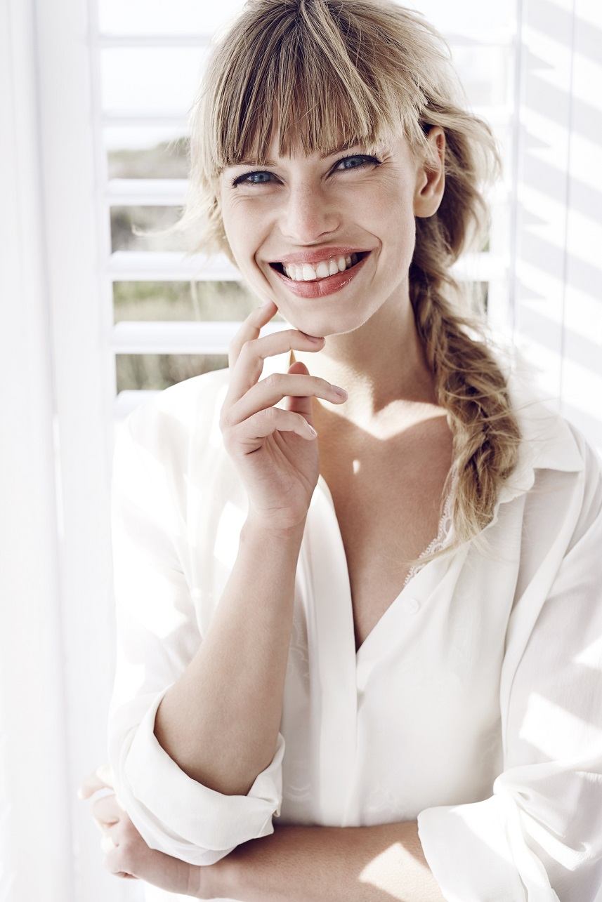 Smiling young woman in white shirt