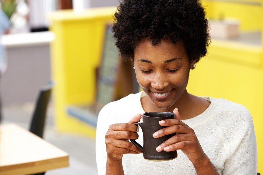 young black woman drinking coffee