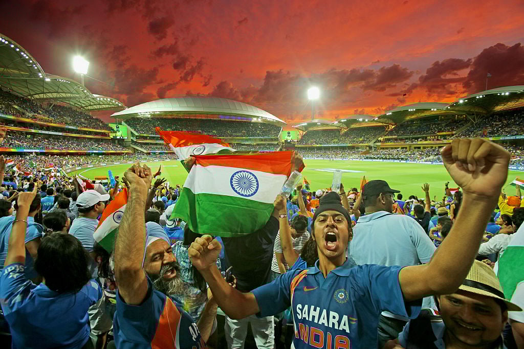 Indian fans celebrate at a cricket match.