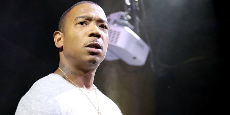 Ja Rule is on stage with a tight white shirt and a gold chain.