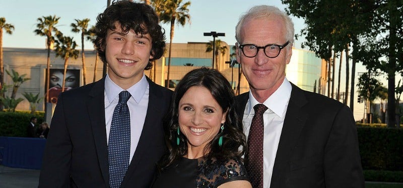 Julia Louis-Dreyfus (C) with son Charles Hall and husband Brad Hall pose together in black outfits.