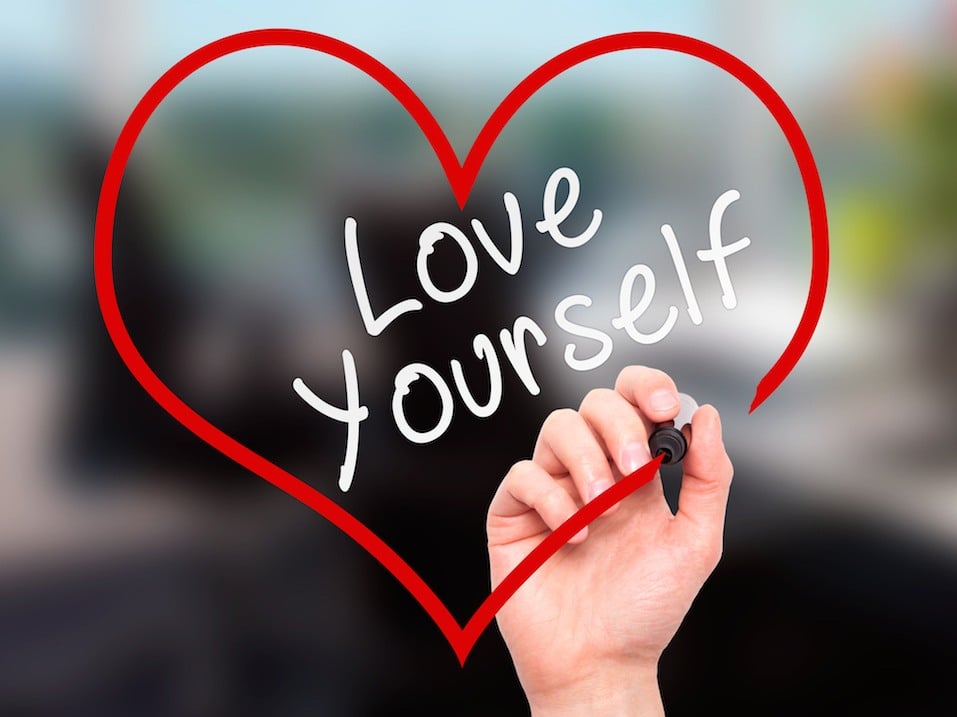 Man Hand writing Love Yourself with marker on transparent wipe board Man Hand writing Love Yourself with marker on transparent wipe board