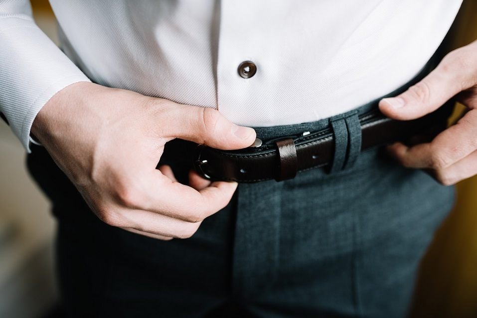 Man corrects belt