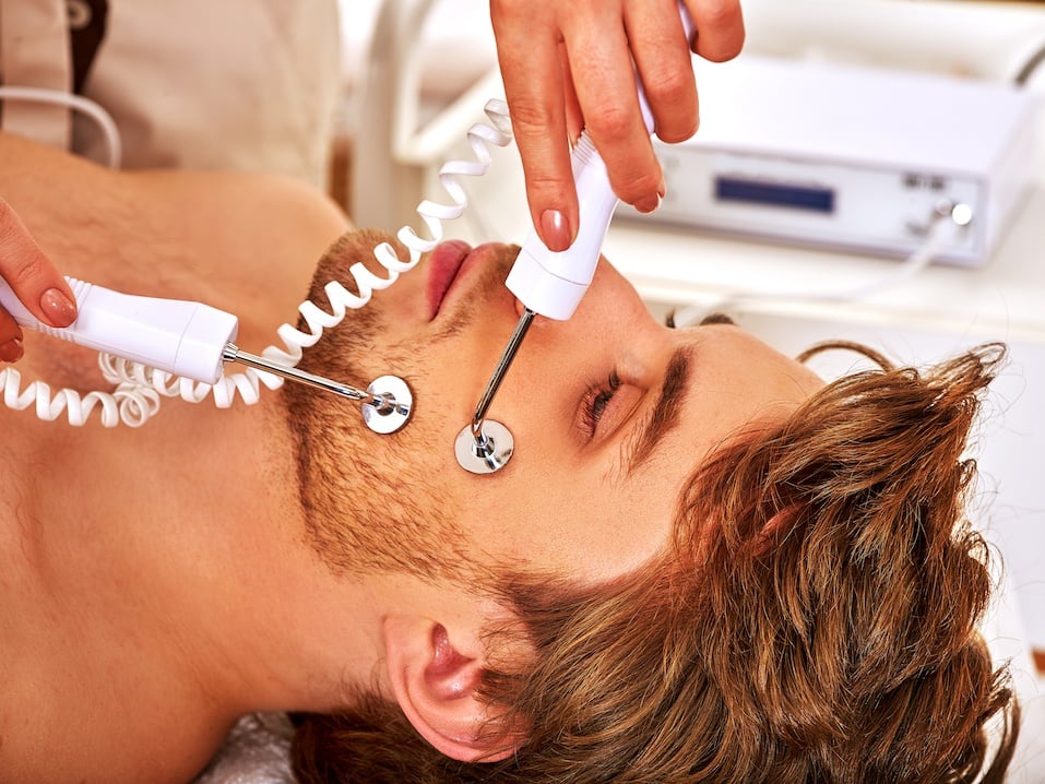 Man receiving electric facial peeling hydradermie massage
