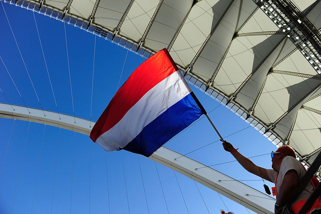 A Netherlands fan waves a flag as he enjoys the atmosphere prior to the 2010 FIFA World Cup South Africa Group E match between Netherlands and Japan