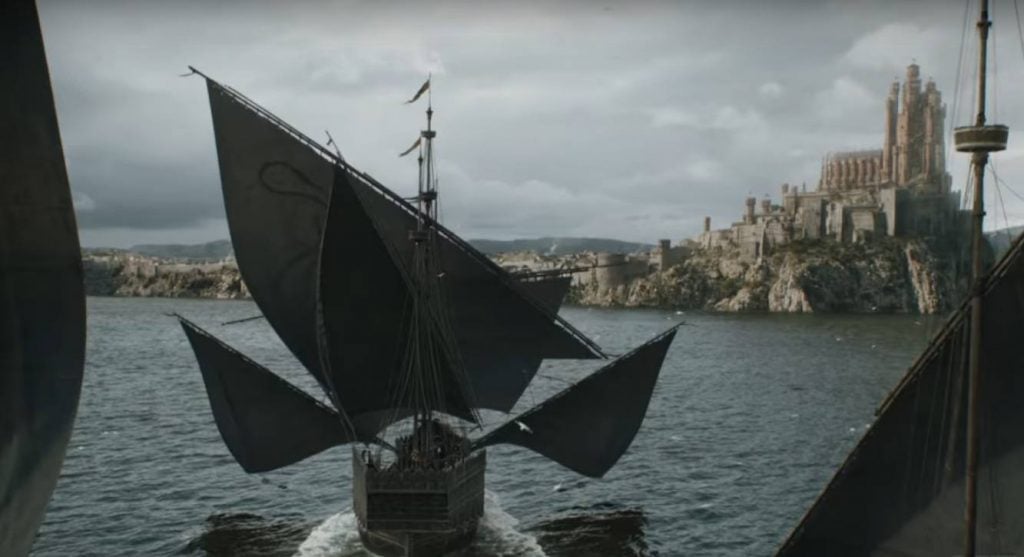 Ships sailing toward a castle on a hill at King's Landing