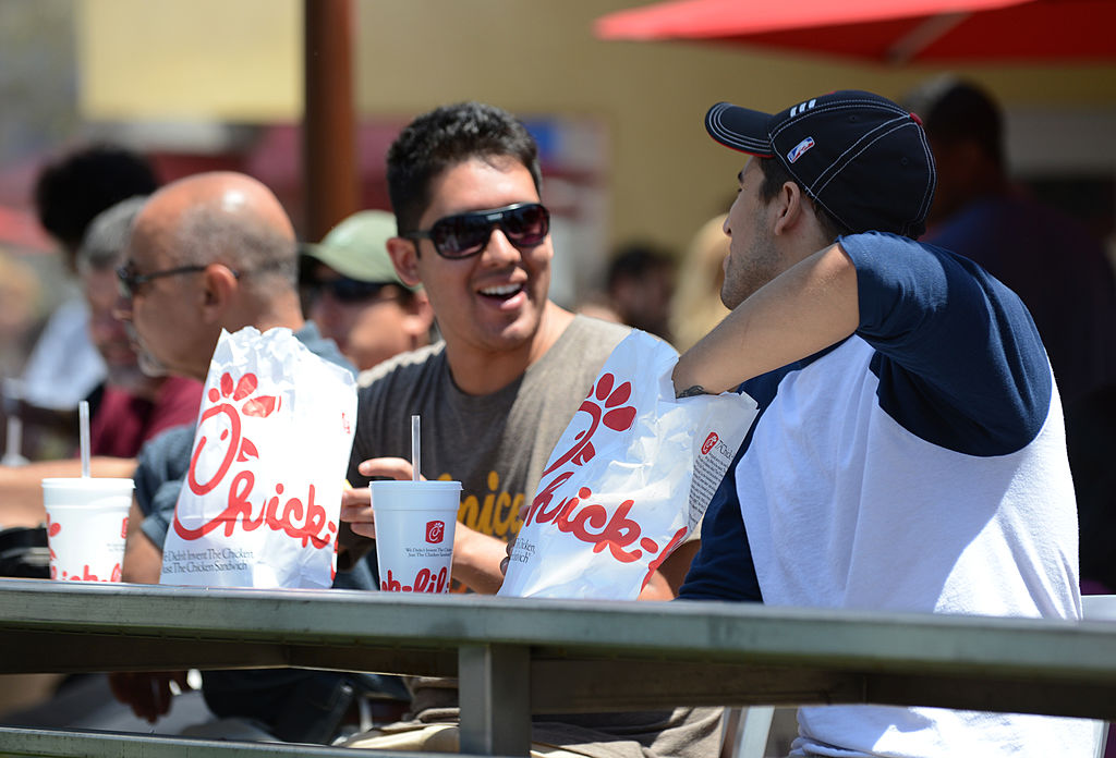 Two men prepare to have lunch on the patio of the Chick-fil-A in Hollywood, California