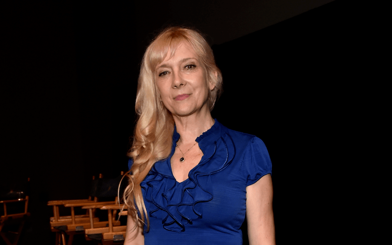 Glenne Headly stands in front of a row of chairs