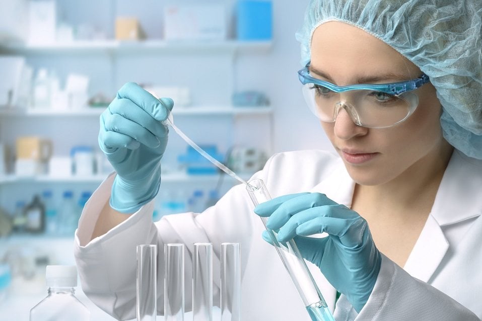 scientist loads liquid sample into test tube