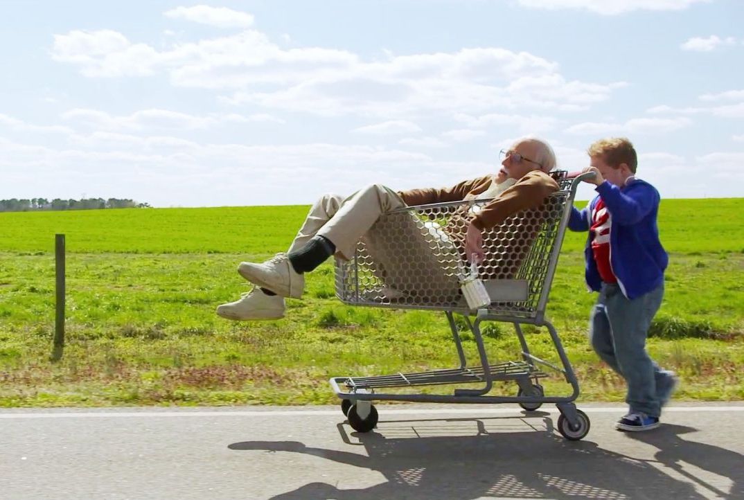 Johnny Knoxville in "Bad Grandpa" being pushed in a shopping cart