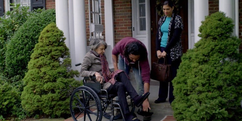 Blanca smiles as Diablo is putting an old woman in her wheelchair.