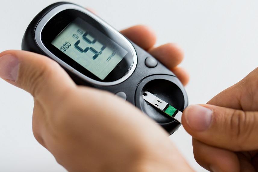 Man checking blood sugar level