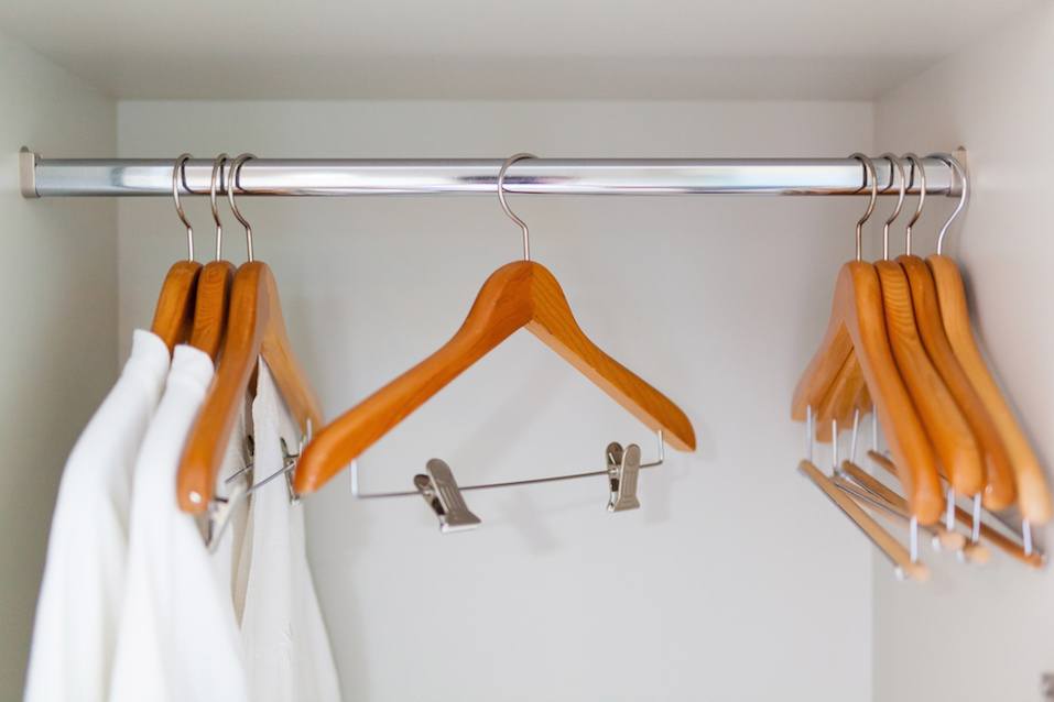 clothes hangers and white shower gown in clothes chest