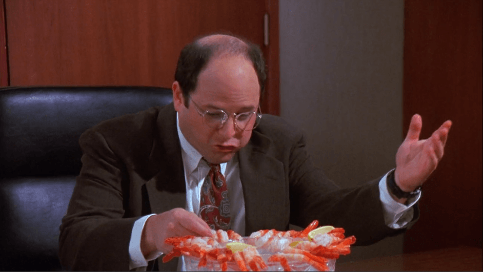 George Costanza disregards office etiquette and dives into a bowl of shrimp