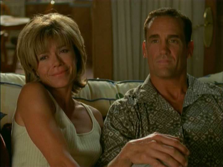Gail and Mitch Leery sitting together on a couch
