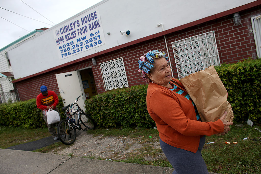 A woman collects groceries from a food bank food bank