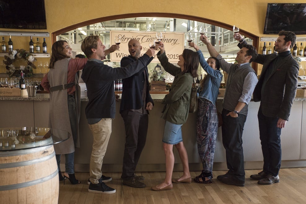 A group of friends raise their glasses in a toast