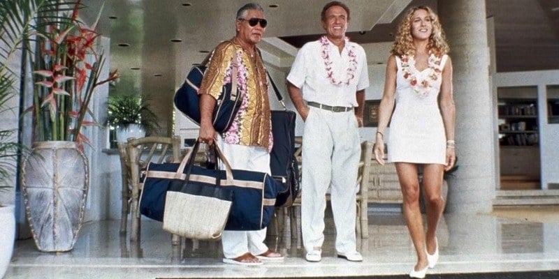 The cast of Honeymoon in Vegas is standing in a lobby of a hotel in white outfits.