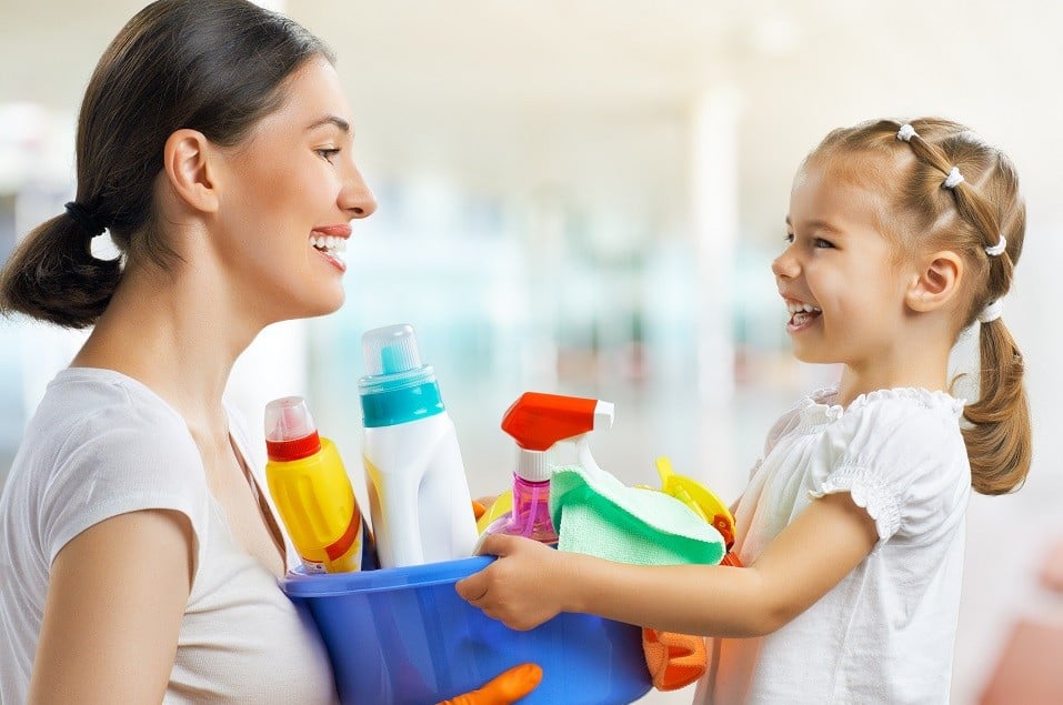 mother and daughter with cleaning supplies