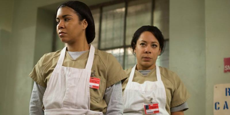 Aleida and Maria are in aprons and hair nets.