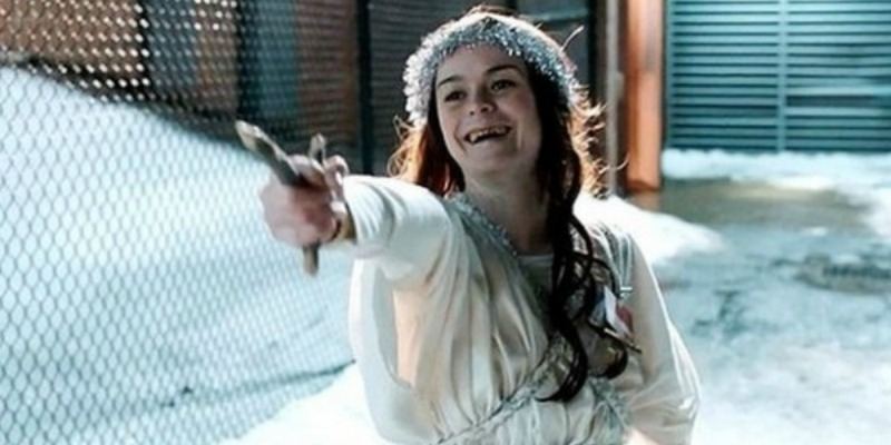 Pennsatucky is laughing has she is weidling a sharp crucifix.