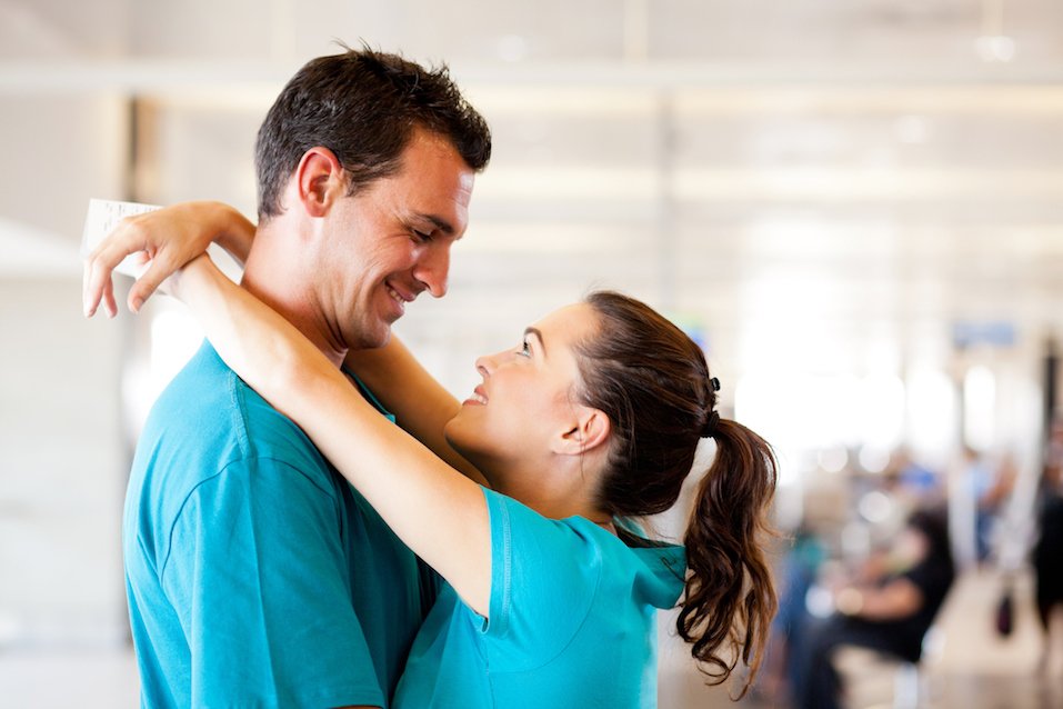 young couple say good bye at airport