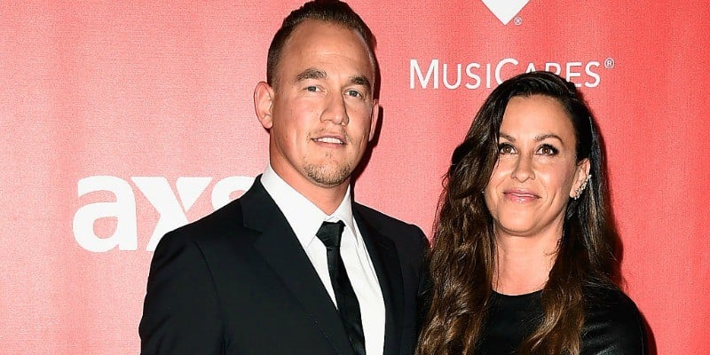 Alanis Morissette and Mario Treadway pose together on the red carpet.