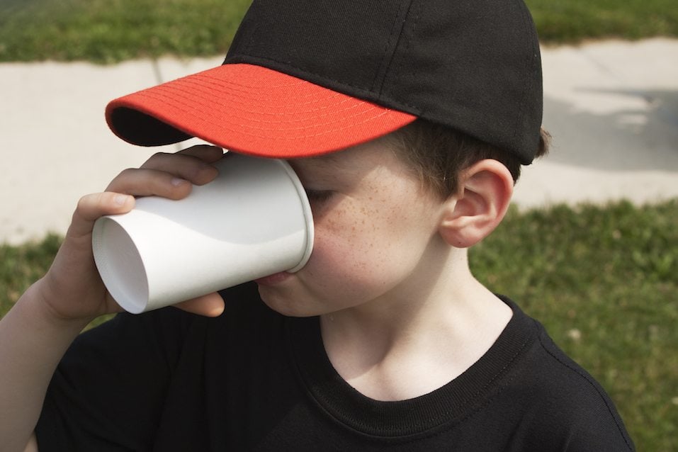 Boy Drinking From a Paper Cup
