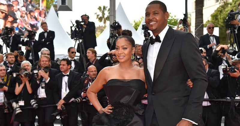 Carmelo and Lala Anthony are posing together on the red carpet.