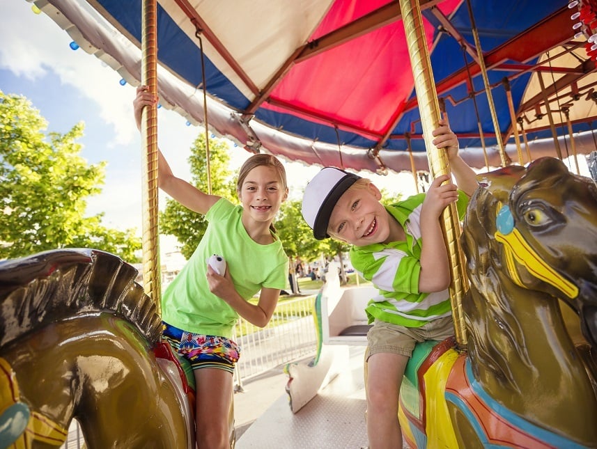 kids enjoying a ride on a fun carnival carousel