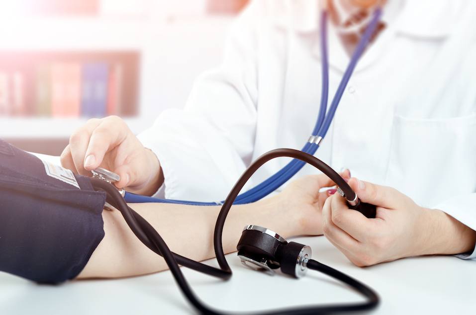 Doctor measures the pressure of the patient Doctor measures the pressure of the patient