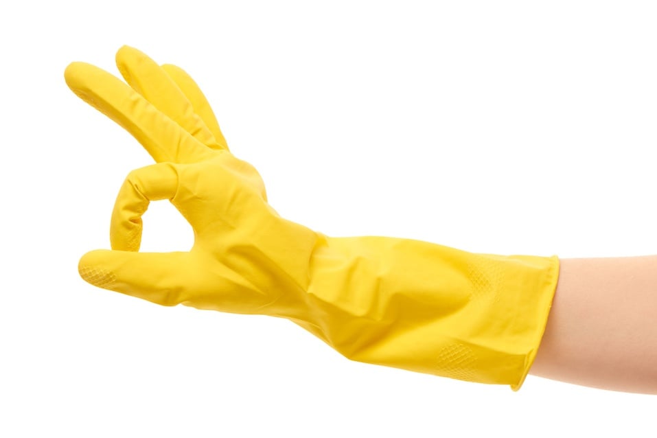 Female hand in yellow protective rubber glove