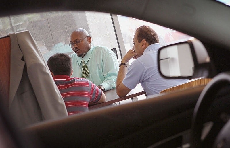 LINCOLNWOOD, IL - AUGUST 30: Wil Jordan (C), a salesman at the Grossinger Autoplex car dealership, speaks with customers on August 30, 2010 in Lincolnwood, Illinois. A strong demand for automobiles helped to drive consumer spending in July to its strongest pace in four months.