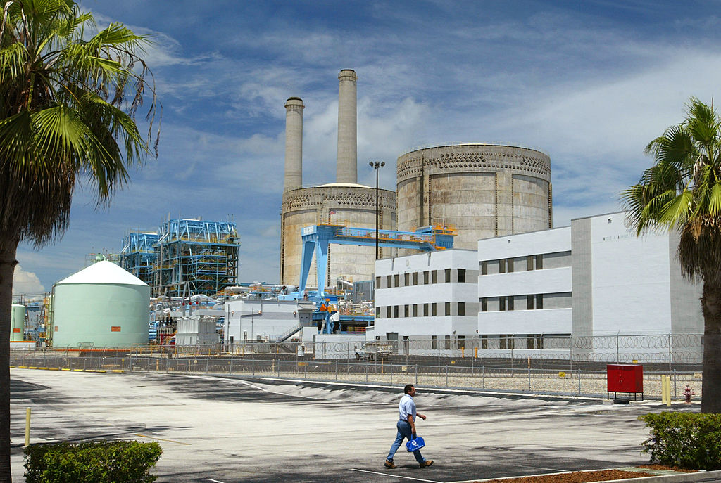 A worker walks by a Florida power plant