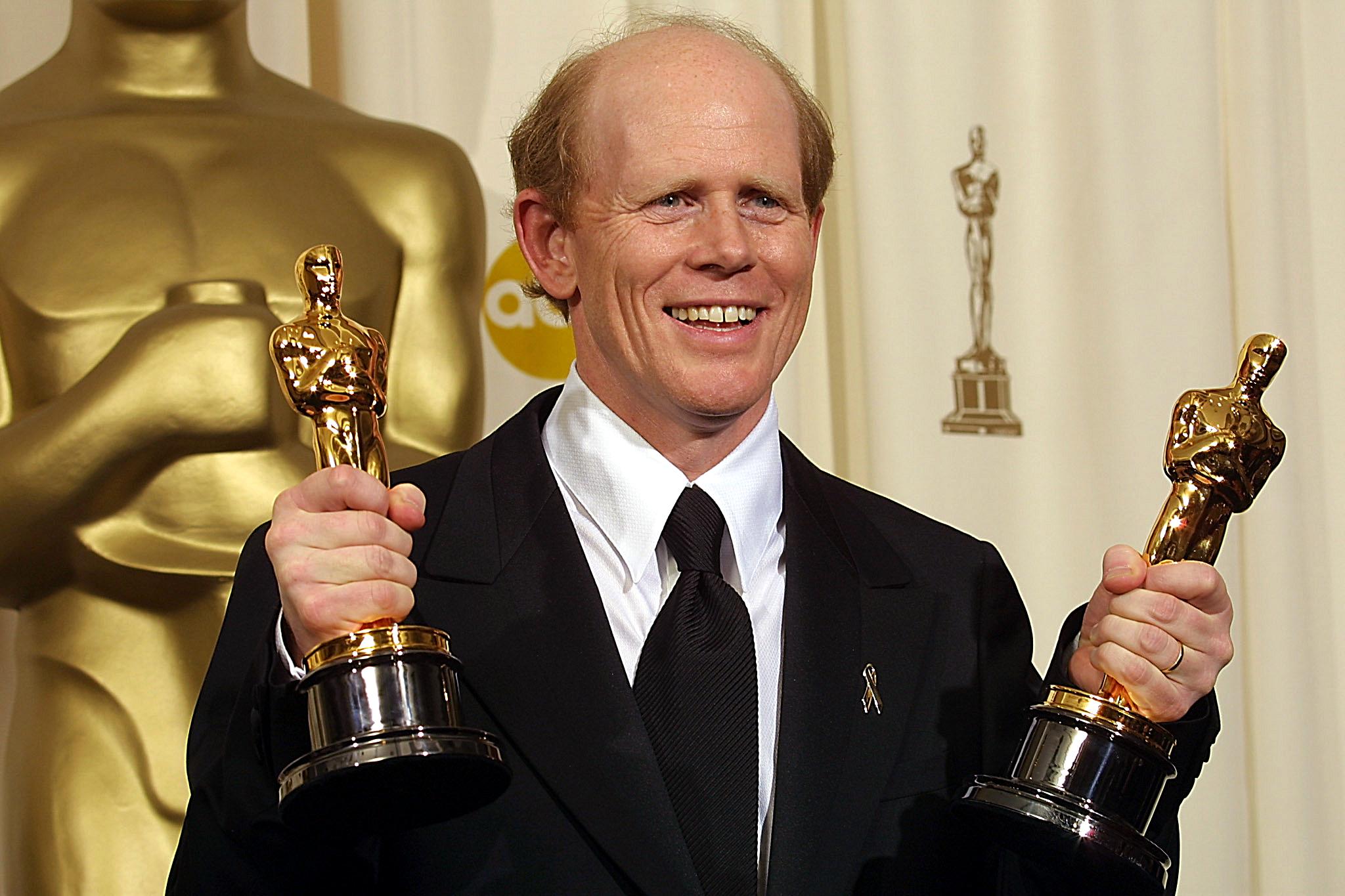 Ron Howard holds his Oscars and smiles. Ron Howard holds his Oscars and smiles.
