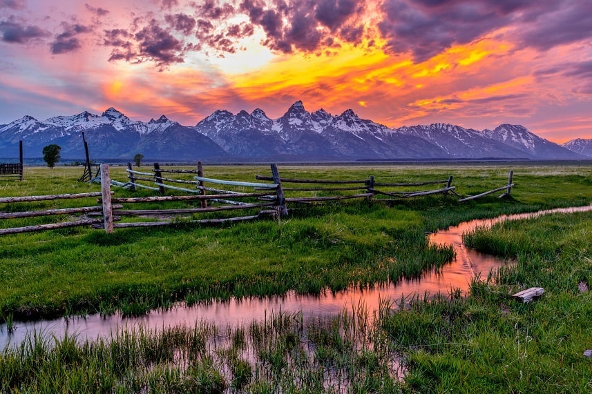 https://www.cheatsheet.com/wp-content/uploads/2017/07/Golden-Fiery-Sunset-at-Grand-Teton.jpg