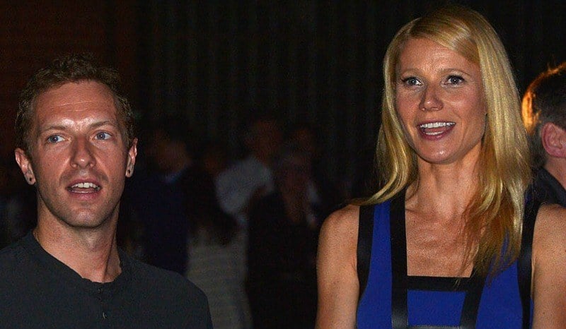 Gwyneth Paltrow and Chris Martin are talking and smiling.