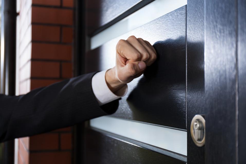 Hand knocking on the door
