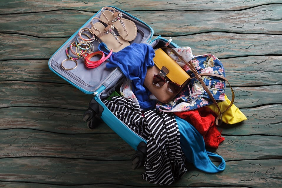 Opened suitcase with crumpled clothes