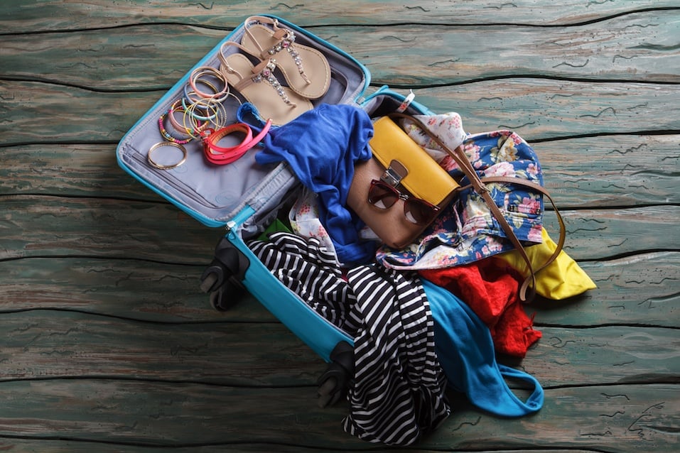 Open suitcase with crumpled clothes
