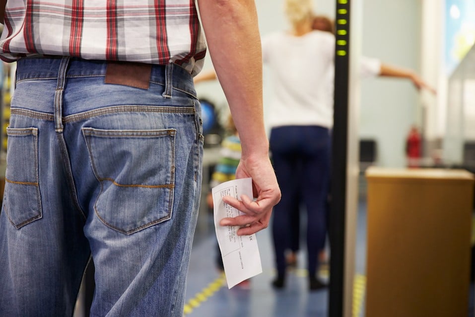 Passenger Passing Through Security Check At Airport