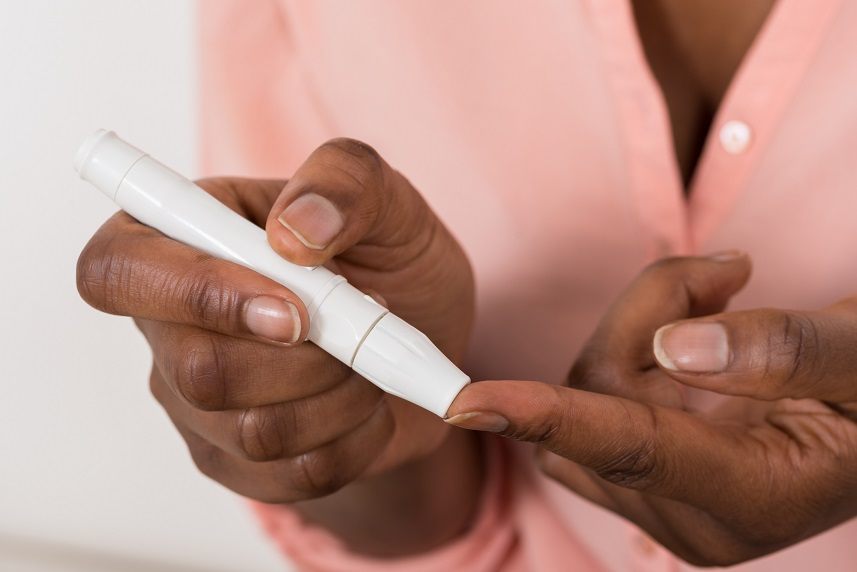 Person's Hand Checking Blood Sugar