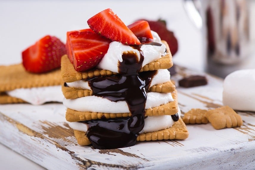 smores with marshmallow, graham crackers, strawberry and chocolate sauce