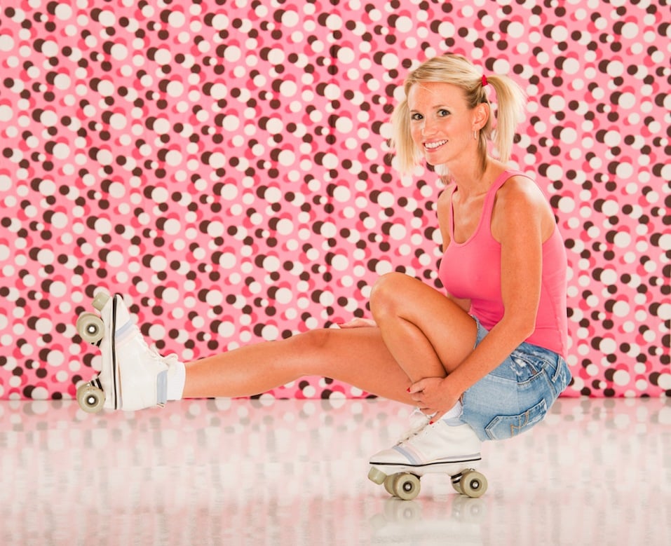 Retro roller skating woman, against a retro polka dot background