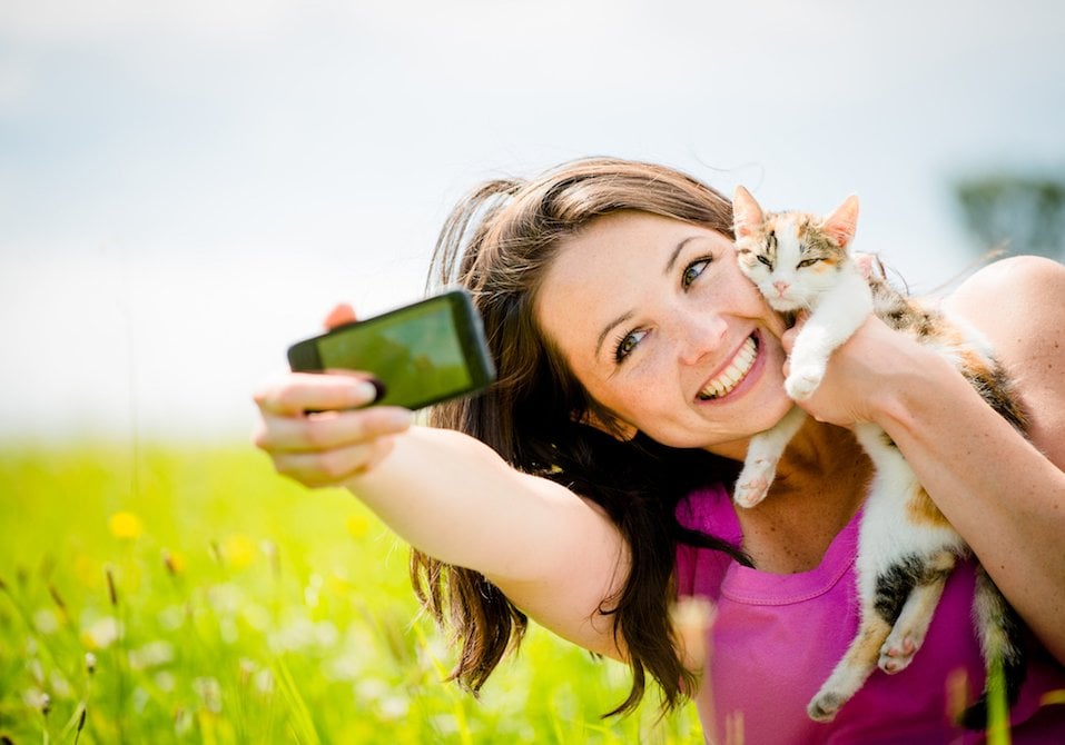 woman and her cat taking a selfie