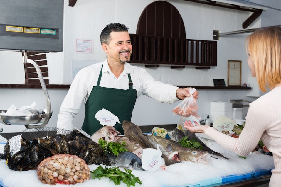 Seller and customer in fish store