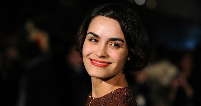 Shannyn Sossamon is smiling and posing on the red carpet.