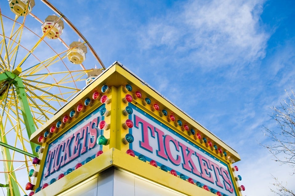 Tickets sign at county fair with Ferris wheel